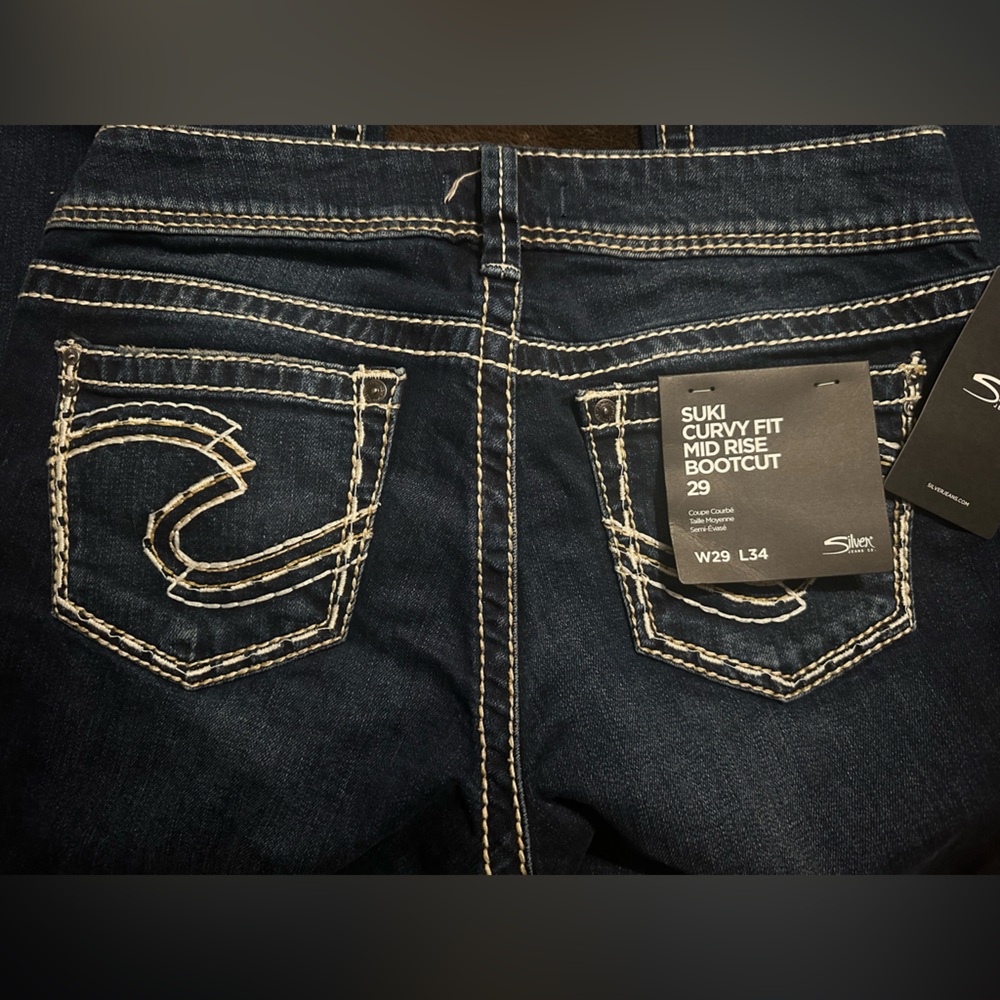 Silver bootcut jeans. NWT